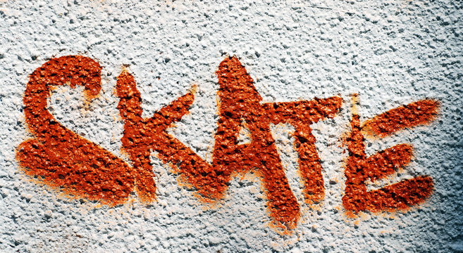 Fototapeta Skate graffitied on the wall of a public skate park.