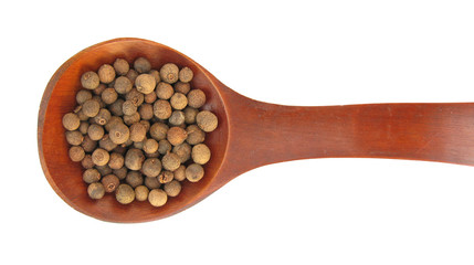 Allspice or Jamaica pepper peppercorns in wooden spoon
