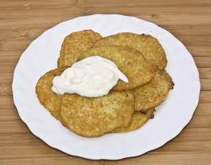Traditional delicious potato pancakes served with sour cream