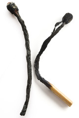 a burned and half-burned matches on white