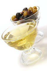 olive oil with green, black and brown olives inside bowls