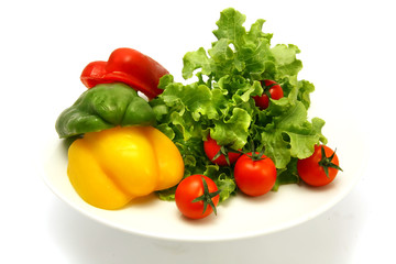 raw vegetables on white dish isolated over white