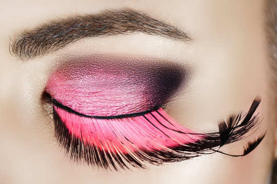 Macro eye of a woman with pink smoky eyeshadow