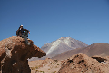 Hikker in front of active volcano in Bolivia
