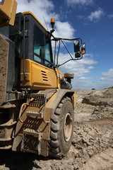 Vertical shot of a dumper truck in a quarry environment.