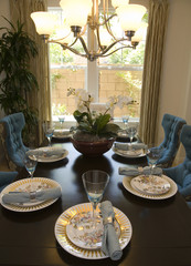Luxury home dining table with exquisite tableware.
