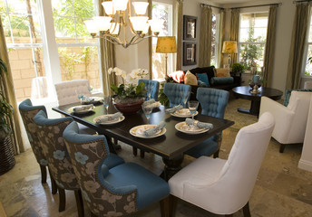 Dining table with luxury tableware and furniture.