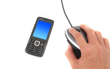 A man is using a mouse and a black mobile phone