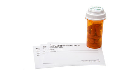 A medical prescription pad and prescribed pills. © Rob Byron
