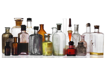 old pharmacist's bottles and beakers on white