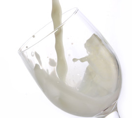 Crystal glass with splash of poured milk