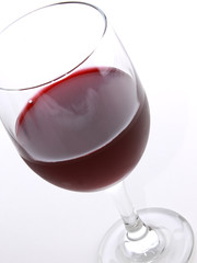Crystal glass of red wine with light reflection