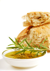 Bowl of extra virgin olive oil and crusty bread with of rosemary