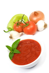 Tomato soup and vegetables isolated on white