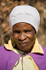 Old african woman in the village dressed in church uniform