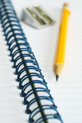 Yellow pencil and sharpener on notebook