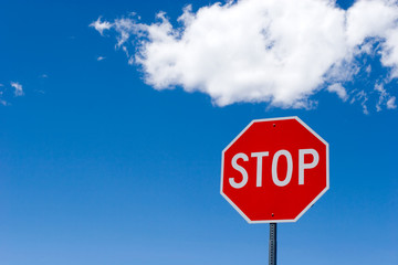Stop sign for traffic against blue sky