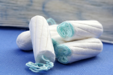 health care and medicine - white tampons on blue background - obrazy, fototapety, plakaty