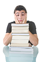 Stressed young student with a pile of books to read.