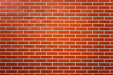 Photo of a red brick wall pattern.
