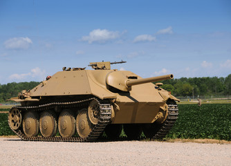 World War II era tank on a dusty road