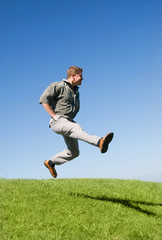 Fototapeta na wymiar happy jumping businessman on the hill