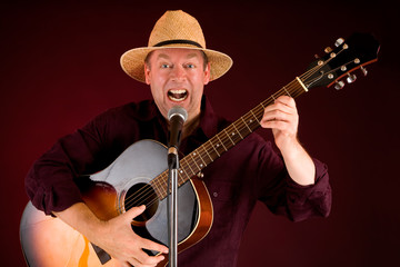 Obraz premium Singing and Playing Acoustic Guitar