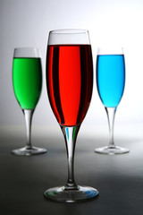 red green and blue colored cocktail over white