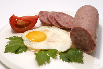 sausage and fried egg with slices and tomato