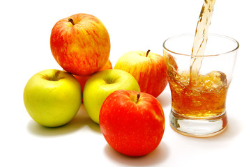 apples over white with filled glass