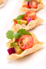 Corn tortilla chips fill with fresh cherry tomatoes salsa..