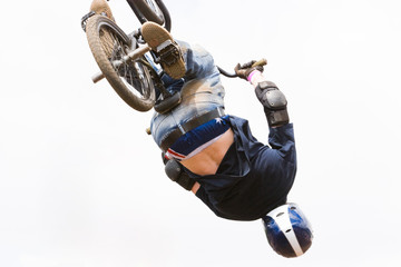 A BMX (Bicycle Moto-cross(X)) in the air against a clouded sky