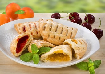 Sweet pies filled with cherry and apricot jam