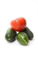 Cucumbers and tomato on white background