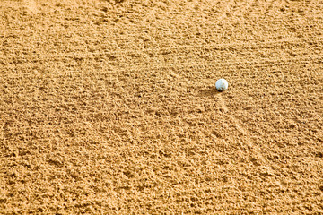 A golf ball in a sand trap