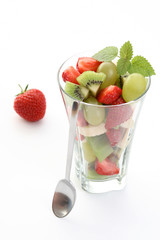 delicious fruity salad in glass on white background