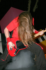 Headbanging rock guitarist in rock concert.