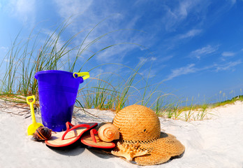 Pretty array of beach accessories on sand dune