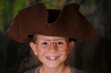 Portrait of a young boy wearing a pirates hat
