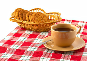Biscuits in the straw basket and a cup of tea