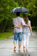 Rear backs of couple embracing each other in the park