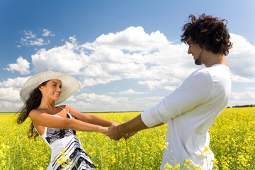 Photo of attractive couple holding by hands and whirling