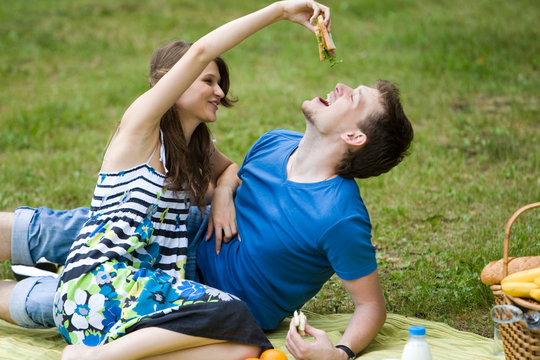 Photo of amorous couple having lunch at picnic