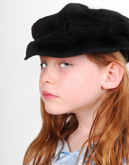 Young girl with very serious or sad face wearing black cap