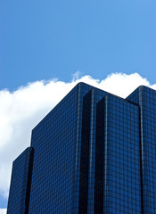 Fototapeta na wymiar angular blue glass office building with rounded edges