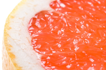 Fresh juicy grapefruit. Close up on a white background.