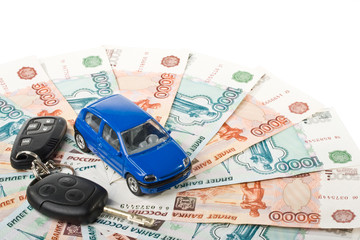 Car, keys and money on a white background