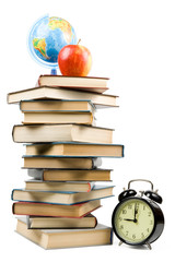 Pile of books, alarm clock and apple. Concept for Back to school