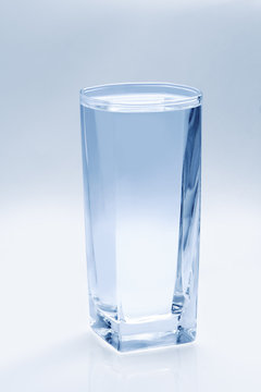 Glass of water on a blue background