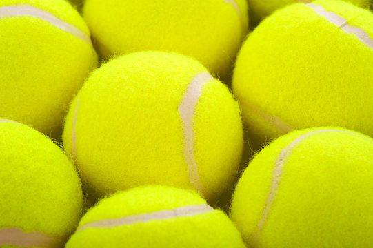 Several tennis balls on a white background with copy space
